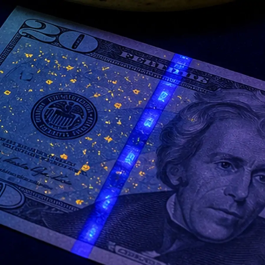 money security strip glowing under black light