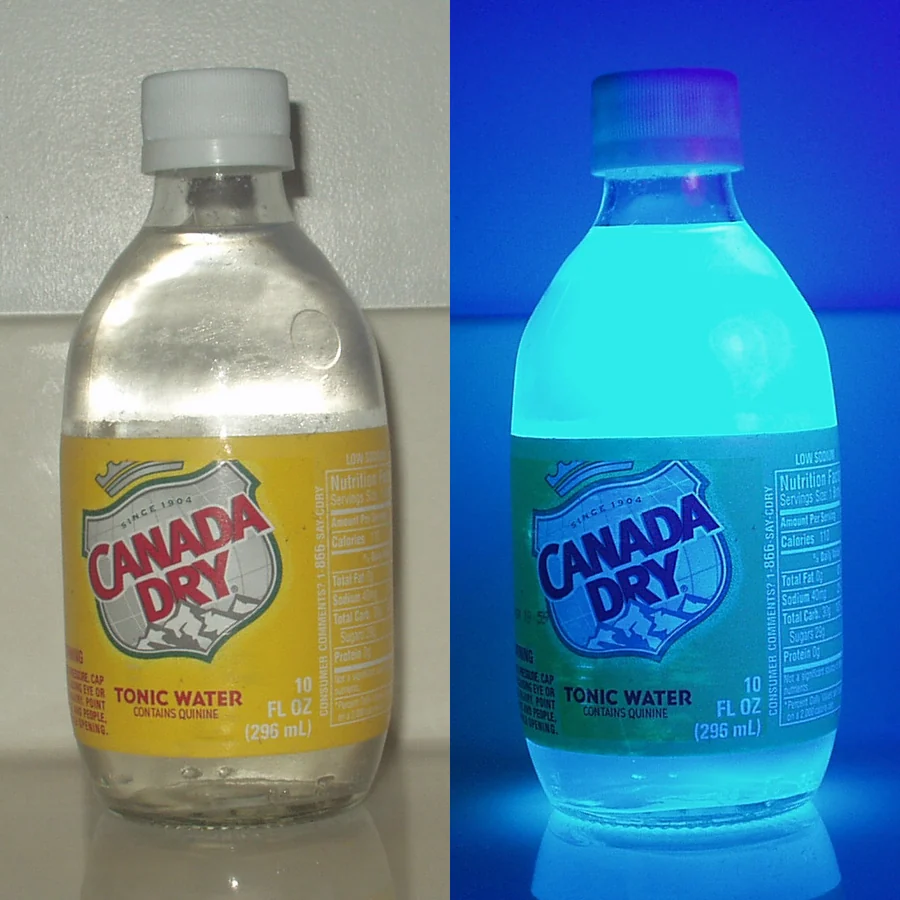 Tonic water bottle before and after ultraviolet blacklight showing quinine fluorescence