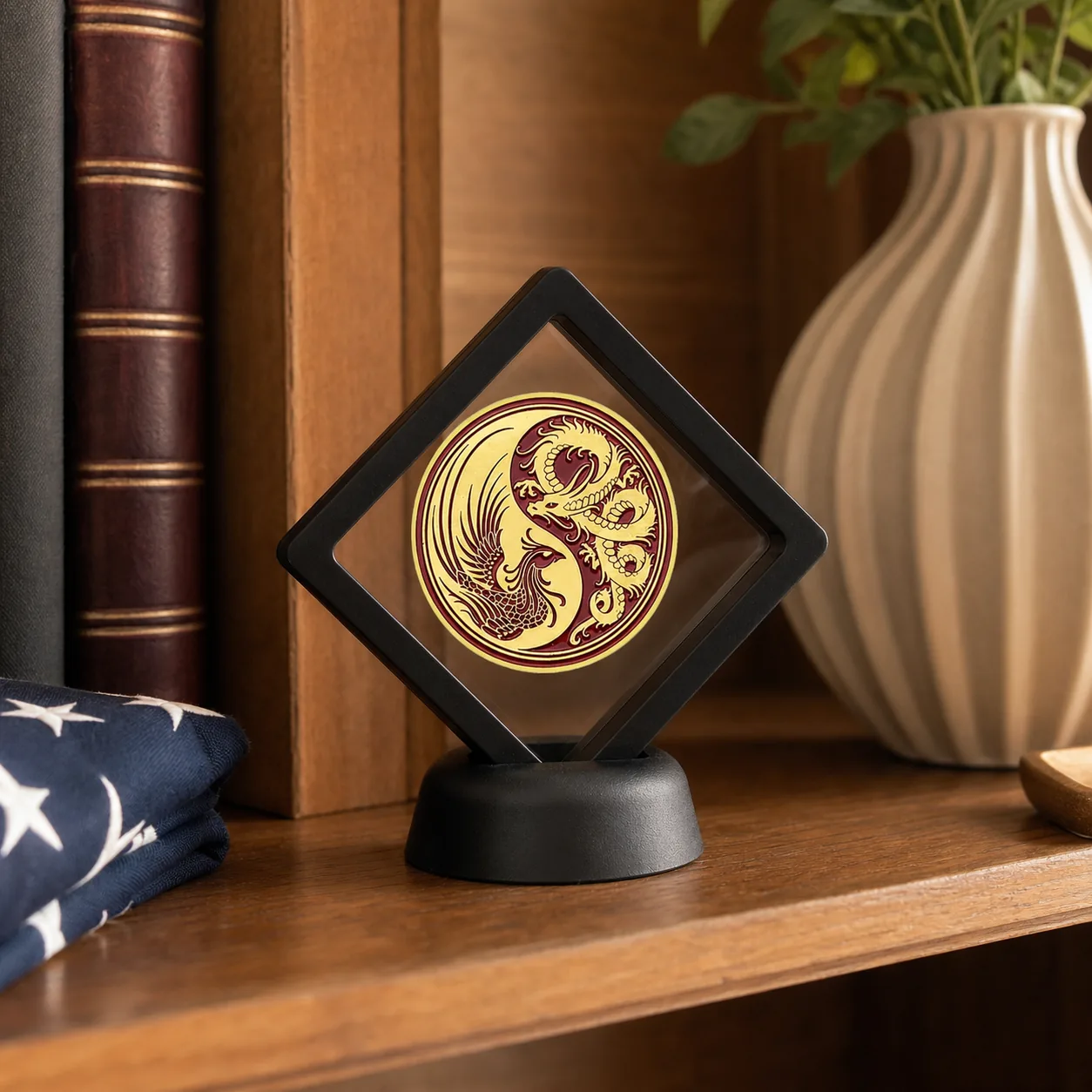 Dragon and Phoenix coin in black floating display stand on a warm wood bookshelf